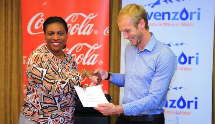 Norah Odwesso, CCBA Group Public Affairs and Communications Executive Director with Masaka Collection Centre, Director Andrew Bownds after signing the MoU.