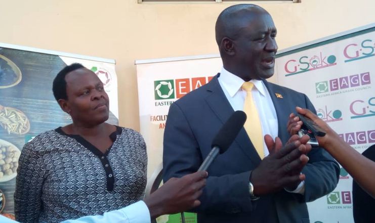Hon. Francis Musa Ecweru speaking to journalists at the launch of the 2018 Agribusiness Expo. Looking on is EAGC Country Director Dr. Rose Omaria.