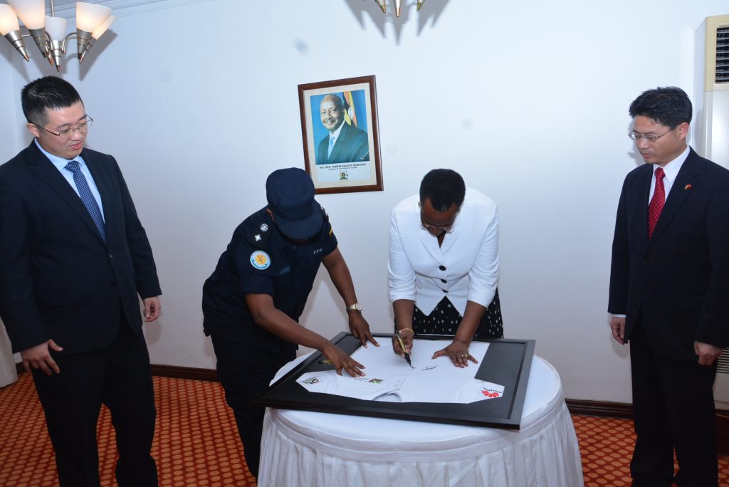 H.E Janet Museveni pictutred signing a Seeds for the Future Program Shirt as Chinese Embassy Charge De Affairs H.E Chu Maoming, and Huawei’s Managing Director Jerry Liujiawei look on during the flag off ceremony at the State House on Thursday 29th March, 2018.