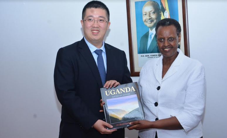 Huawei’s New Managing Director Mr. Liujiawei receiving a book about Ugana from the First Lady Hon. Janet Museveni at a recently concluded Seeds for the Future event at State House Nakasero.