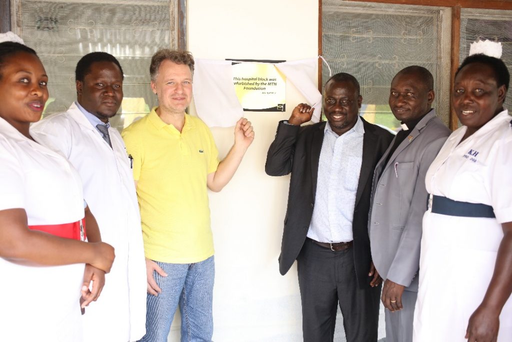 MTN Uganda's CEO, Wim Vanhelleputte poses with the staff hospital in front of the revamped Kabarole hospital on Friday 20th, April 2018.