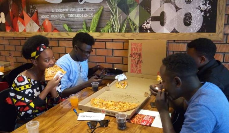 Guests try out "The Epic" pizza during the unveiling ceremony. 