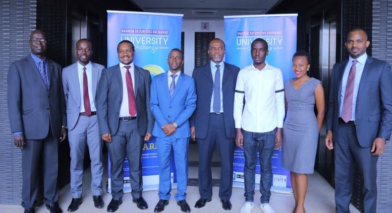 Ahimbisibwe Robin (4L) Nashir Jombwe (3R) pose for a picture with the Uganda Securities Exchange CEO Paul Bwiso (3L) and Capital Markets Authority CEO Keith Kalyegira (4R) after emerging winners in the inaugural USE University Challenge. The challenge is aimed at encouraging the youth to save. 